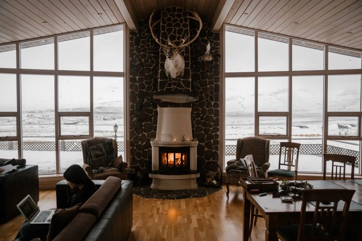 A warm, comfortable living room in winter with a fireplace